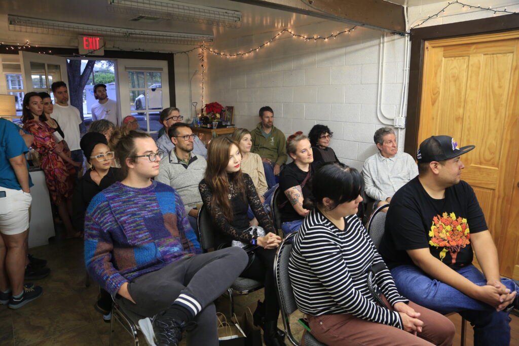 audience sitting in room listening to Fallen Spirits reading