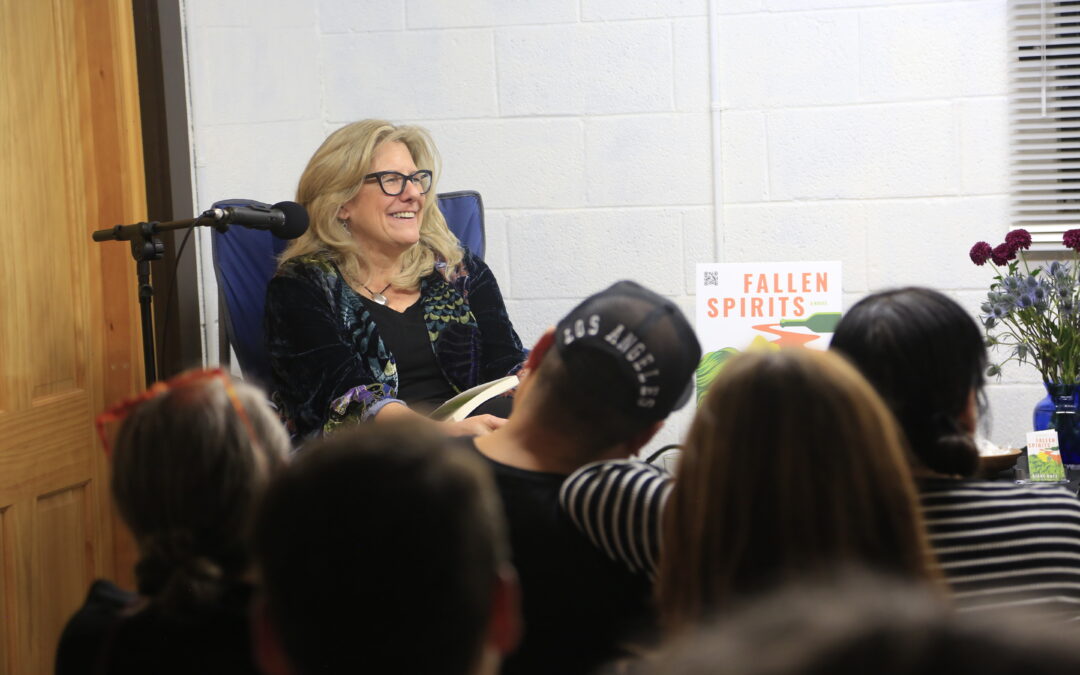 Diane Hatz sitting with audience with Fallen Spirits book