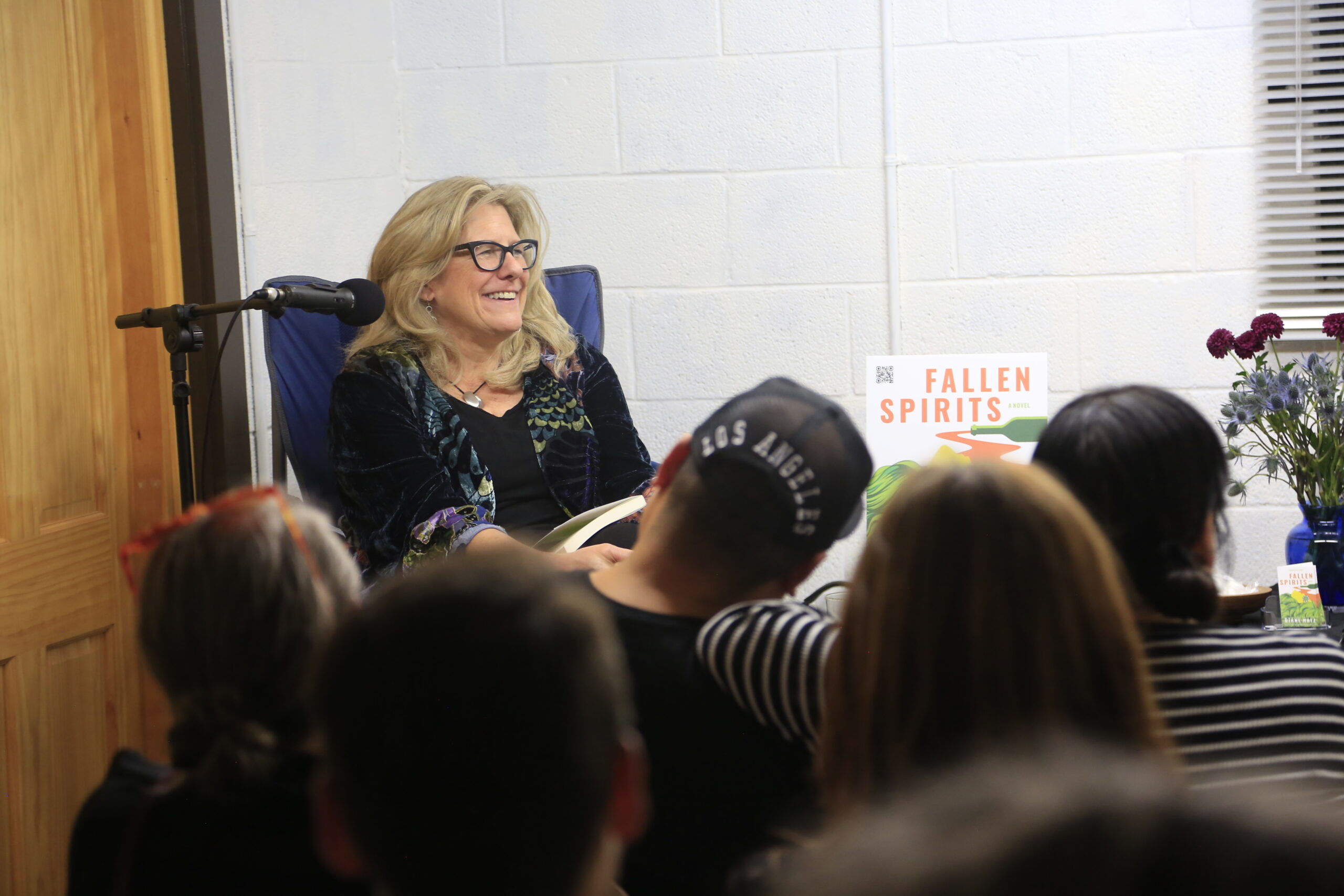 Diane Hatz sitting with audience with Fallen Spirits book