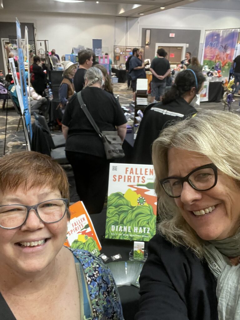 Diane Hatz and a reader with Fallen Spirits book