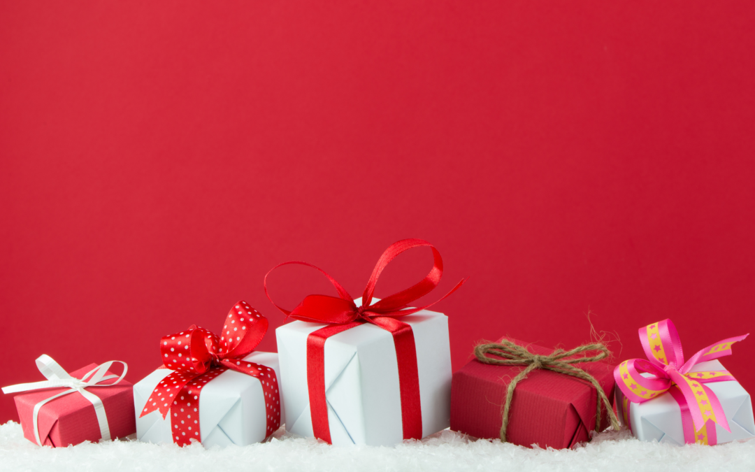 small wrapped presents for Christmas against a red background