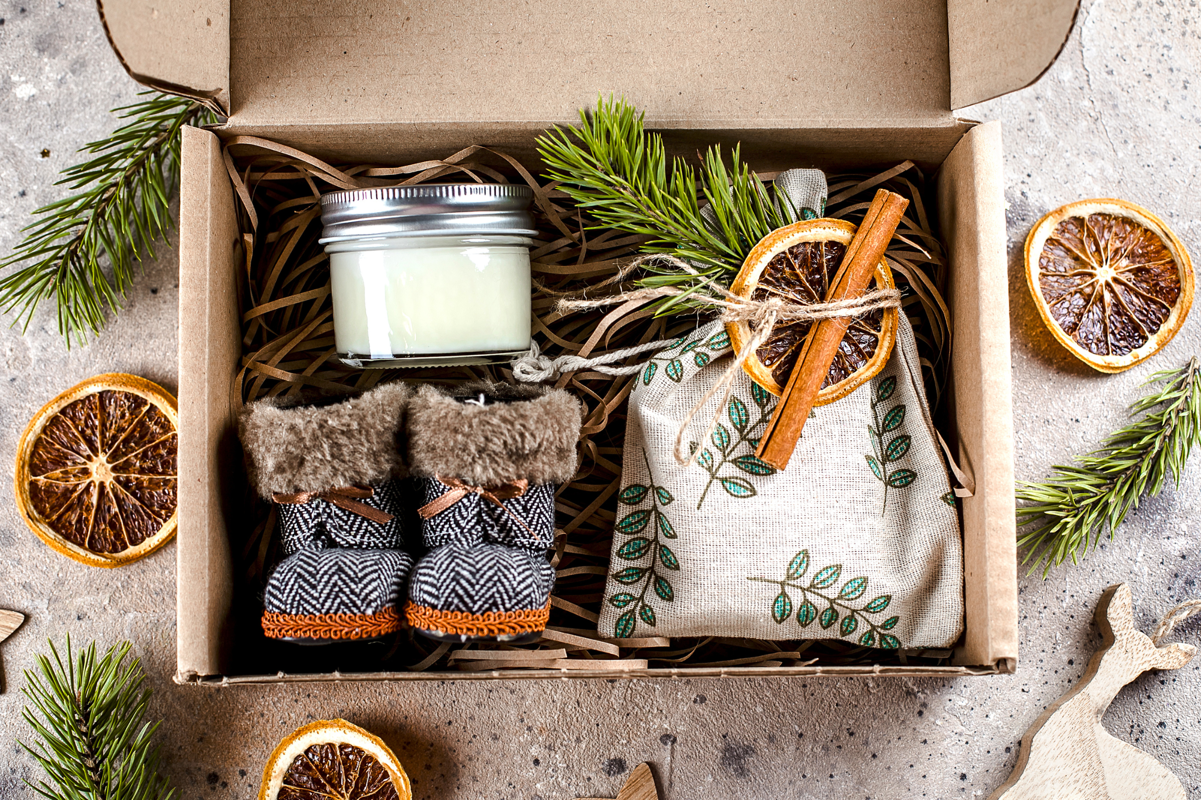 slippers, journal, and candle in brown box