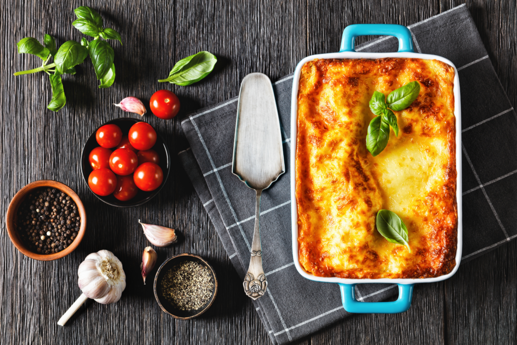 lasagna on table with knife next to it